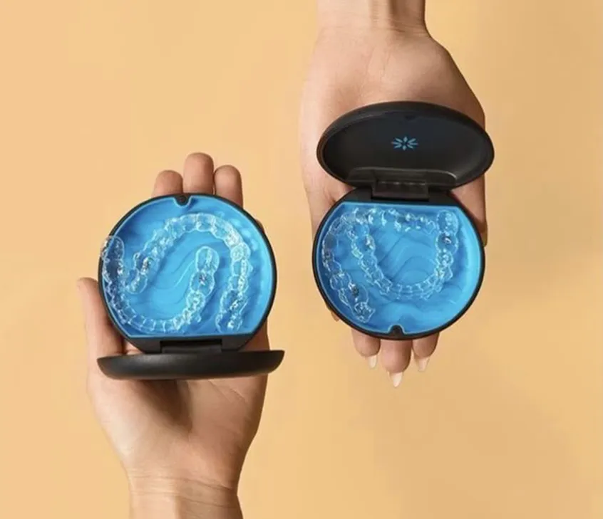 female Invisalign patient smiling with clear retainer